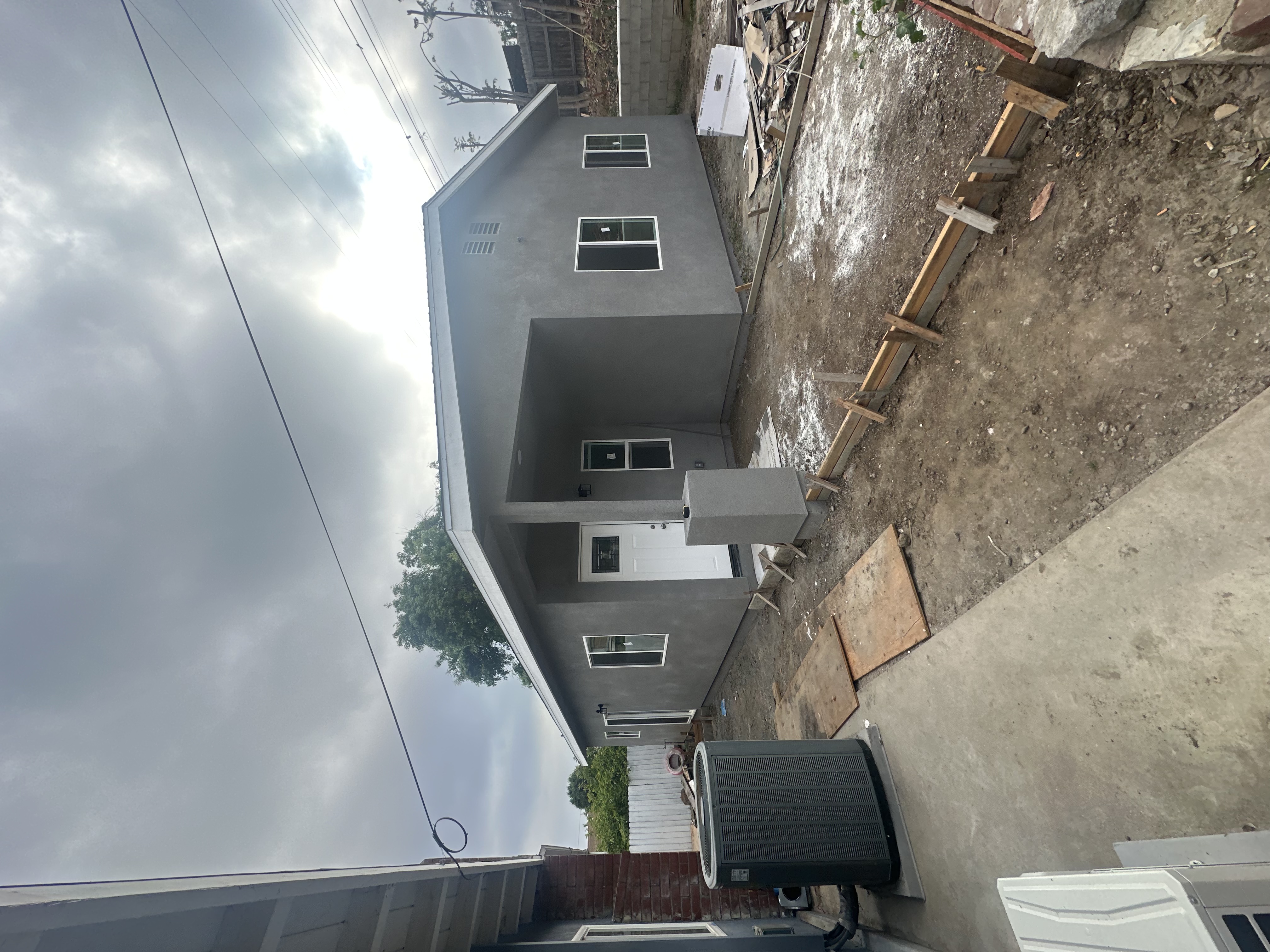 Home exterior mid-remodel with weather barrier